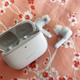 Powerbuds Pro and case on a floral background